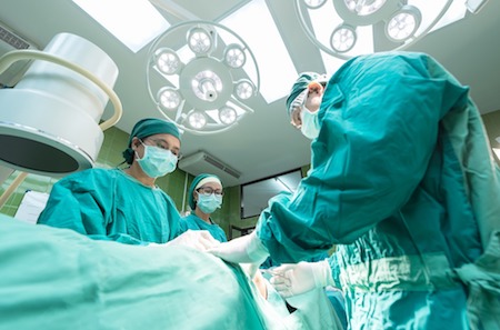 Surgeons performing surgery in an operating room.
